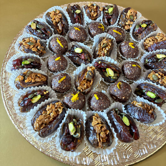 Ramadan and Eid Gifting. Dates Platter. Made locally by HeartiGrub. Luxury Gifting. Organic and Healthy. HeartiGrub Dates and Truffle Ball Platter featuring granola almond butter and cranberry pistachio filled Medjool dates with hazelnut orange truffle balls, a premium Ramadan and Eid gift hamper.