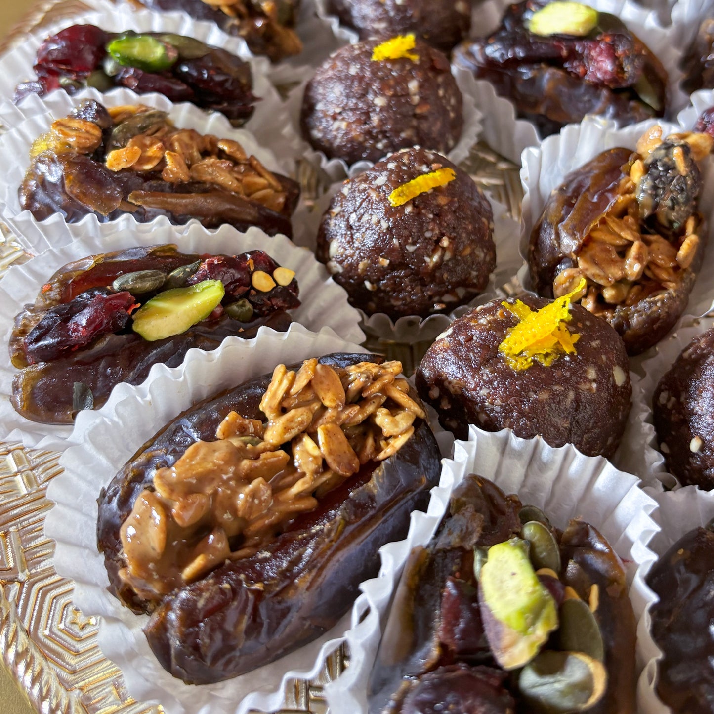 Delivery throughout UAE. Ramadan and Eid Gifting. Dates Platter. Made locally by HeartiGrub. Luxury Gifting. Organic and Healthy. Ramadan and Eid Gifting. Dates Platter. Made locally by HeartiGrub. Luxury Gifting. Organic and Healthy. HeartiGrub Dates and Truffle Ball Platter featuring granola almond butter and cranberry pistachio filled Medjool dates with hazelnut orange truffle balls, a premium Ramadan and Eid gift hamper.