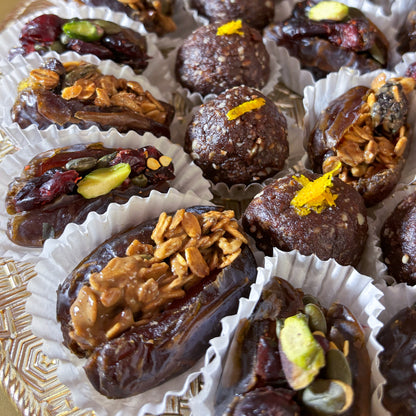 Delivery throughout UAE. Ramadan and Eid Gifting. Dates Platter. Made locally by HeartiGrub. Luxury Gifting. Organic and Healthy. Ramadan and Eid Gifting. Dates Platter. Made locally by HeartiGrub. Luxury Gifting. Organic and Healthy. HeartiGrub Dates and Truffle Ball Platter featuring granola almond butter and cranberry pistachio filled Medjool dates with hazelnut orange truffle balls, a premium Ramadan and Eid gift hamper.