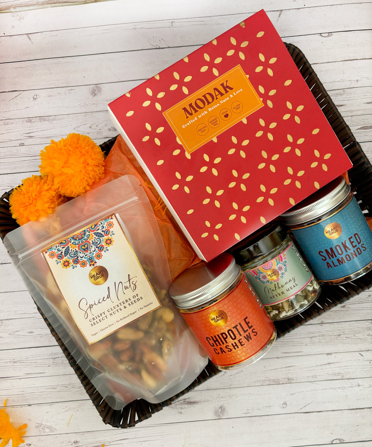 Gift set with Modak, Ganesh Chaturthi items. Gift Basket. Ganesh Chaturthi. Gifting. Made in Small Batches. Deliciously Decadent. Vegan Gluten Free Refined Sugar Free. Delicious Modak. Nuts. Delivery throughout U.A.E. HeartiGrub
