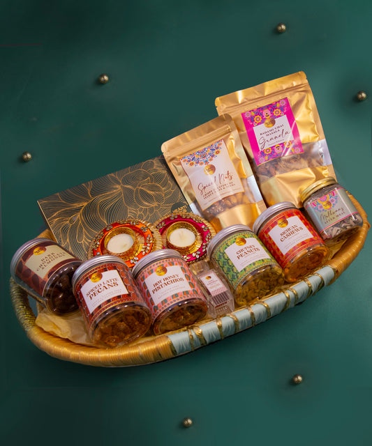 Assorted food items including jars and packets on a decorative tray with a green background. Bespoke Diwali gift. Thoughtful gifts. No Nasties. Clean Ingredients. UAE. Dubai. Abu Dhabi. Sharjah. Delivery throughout UAE. Nuts. Nut Butters. HeartiGrub