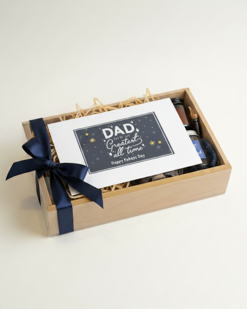 Gift box with a card and blue ribbon on a white background. HeartiGrub. Delivery through UAE. Fathers Day gifts.