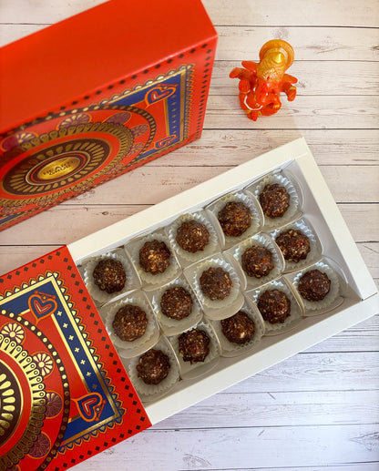 Gift set with Modak, Ganesh Chaturthi items, and a yellow ribbon on a wooden surface. Ganesh Chaturthi. Gifting. Made in Small Batches. Deliciously Decadent. Vegan Gluten Free Refined Sugar Free. Delicious Modak. Nuts. Delivery throughout U.A.E. HeartiGrub