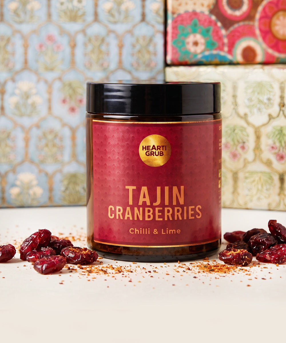 Diwali treats. diwali gifts. Snacks. Healthy Snacks and treats. Dubai. UAe. heartiGrub. A jar of Tajin Cranberries with the label showing the product name and the HeartiGrip brand logo.