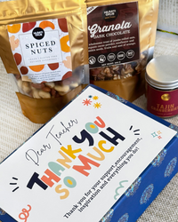 Teacher appreciation Gift Hamper with spiced nuts and granola in the background. HeartiGrub. Made in UAE. Delivery throughout the UAE. Clean Ingredients. 