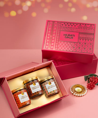 Three jars of honey with labels in a pink gift box. Bespoke Diwali gift. Thoughtful gifts. No Nasties. Clean Ingredients. UAE. Dubai. Abu Dhabi. Sharjah. Delivery throughout UAE. Nuts. Nut Butters