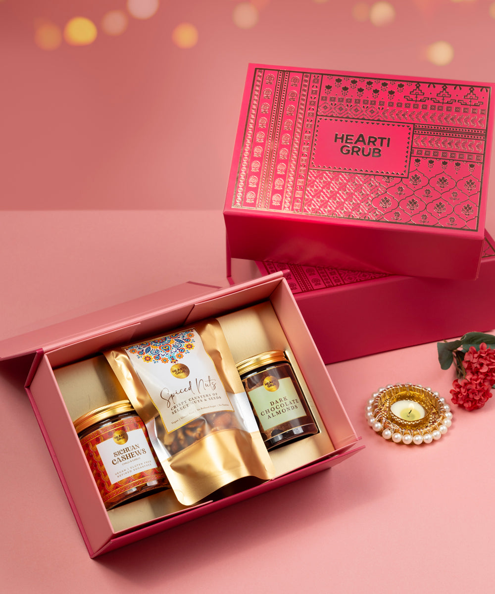Hearti Grub Pink gift box with containing nuts on a pink background. Bespoke Diwali gift. Thoughtful gifts. No Nasties. Clean Ingredients. UAE. Dubai. Abu Dhabi. Sharjah. Delivery throughout UAE. Nuts. Nut Butters
