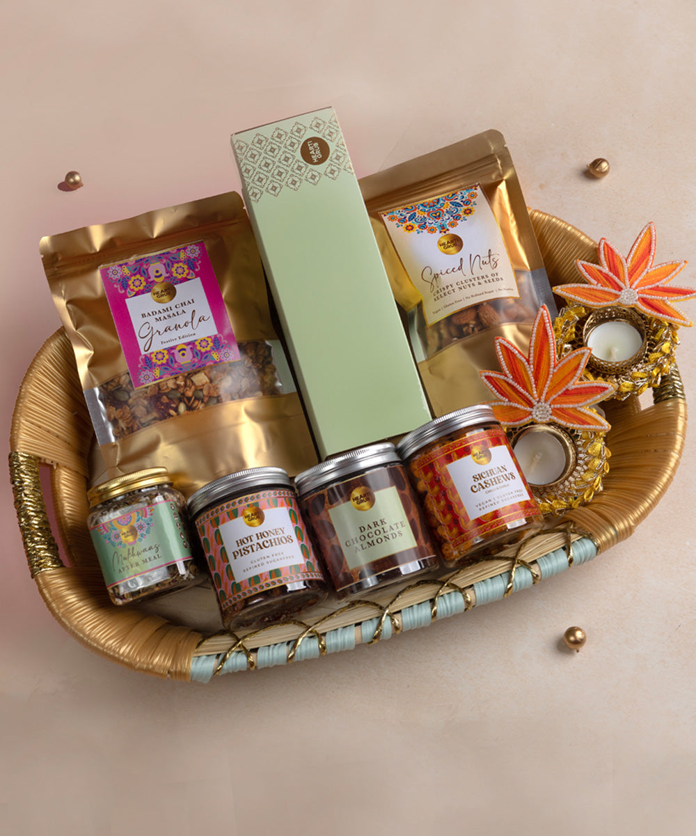 Gourmet gift basket with various items including jars and a box on a beige background. Bespoke Diwali gift. Thoughtful gifts. No Nasties. Clean Ingredients. UAE. Dubai. Abu Dhabi. Sharjah. Delivery throughout UAE. Nuts. Nut Butters