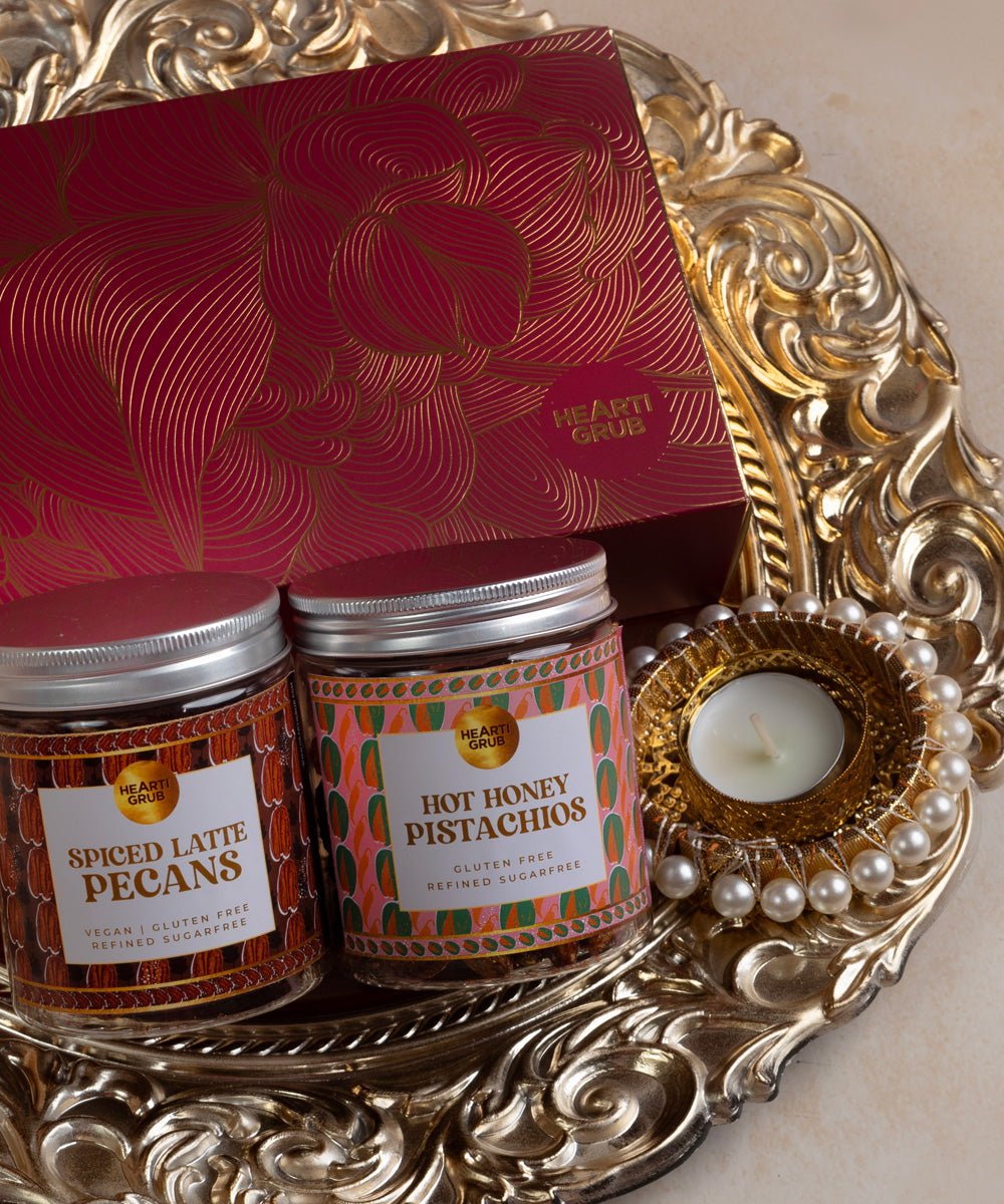 Two small jars on a decorative silver tray with a red card on a beige background. 
Trays and Platters. Luxury Gifting. Bespoke Diwali gift. Thoughtful gifts. No Nasties. Clean Ingredients. UAE. Dubai. Abu Dhabi. Sharjah. Delivery throughout UAE. Nuts. Nut Butters