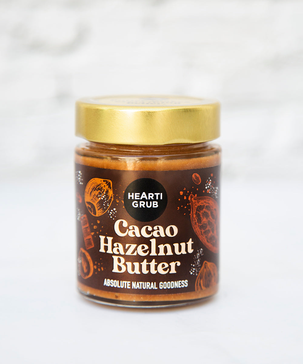 CACAO HAZELNUT BUTTER by HEARTIGRUB. RAW CACAO, TURKISH HAZELNUTS, HINT OF HONEY. THE BETTER HAZELNUT SPREAD by HEARTIGRUB. Our Best Seller. The Better Cacao Hazelnut Spread. No Nasties. No Palm Oil. Made proudly in Dubai, UAE. Small BAtch Made. Artisanal Nut Butters